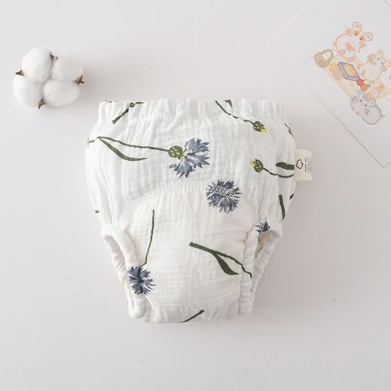 White baby training diaper with blue cornflower floral print. Soft reusable cotton baby care diaper for potty training.