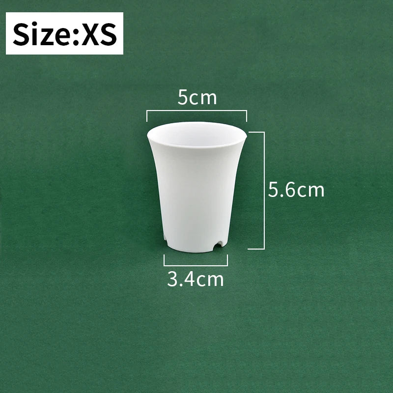 Extra small white plastic nursery seedling pot, tapered sides and drainage holes
