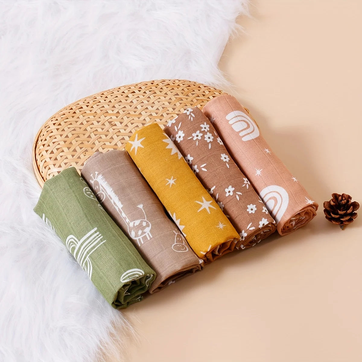 Set of 5 baby muslin swaddle blankets in earthy colors with floral, rainbow, star, and animal prints.
