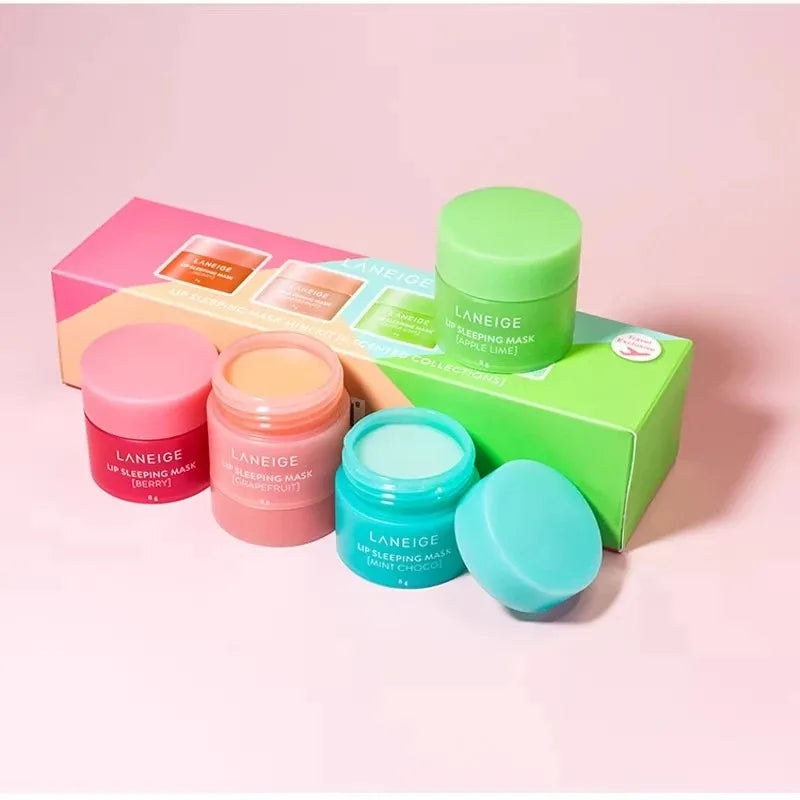 Laneige Lip Sleeping Mask set in colorful jars with creamy, moisturizing textures for lip care on a pink background.