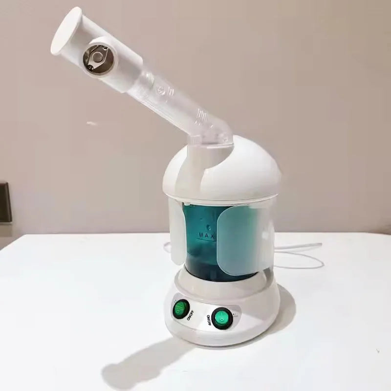 White portable facial steamer with blue water tank, adjustable nozzle, and green power buttons for home spa skincare.
