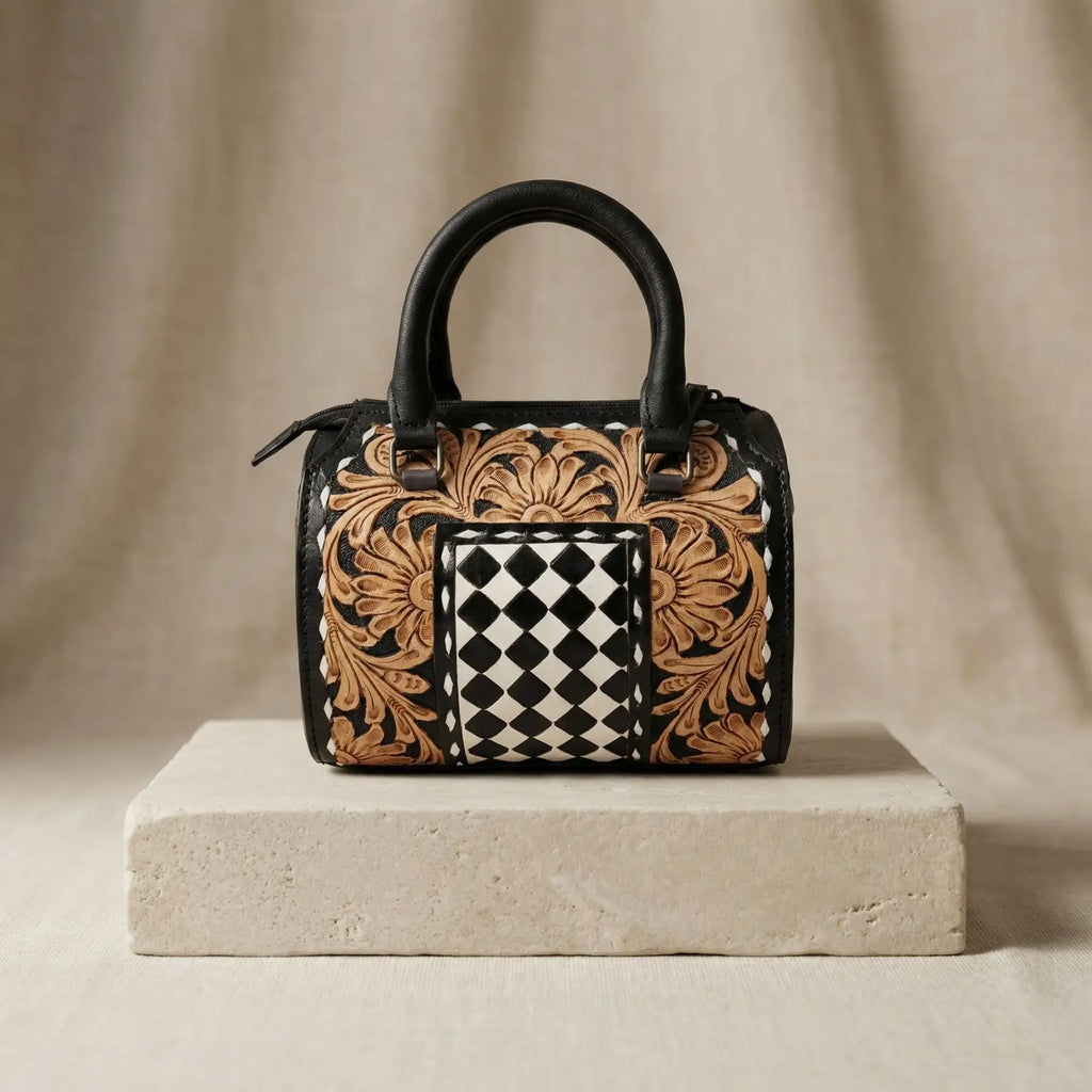 Luxury genuine leather speedy trunk bag with floral tooling, black and white checkerboard center, and zipper closure.