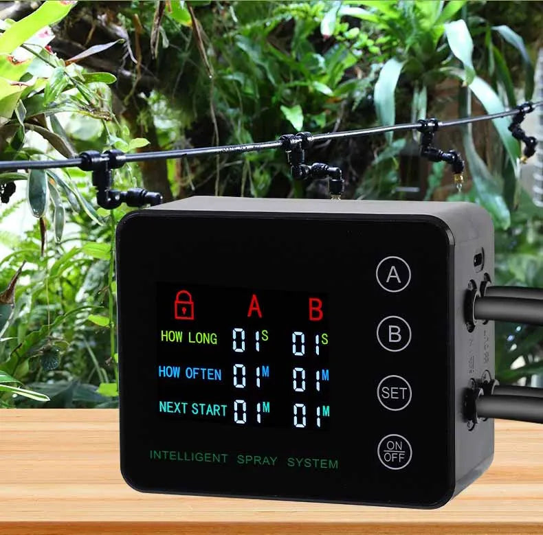 Black mist timer controller with display and side ports connected to spray tubes