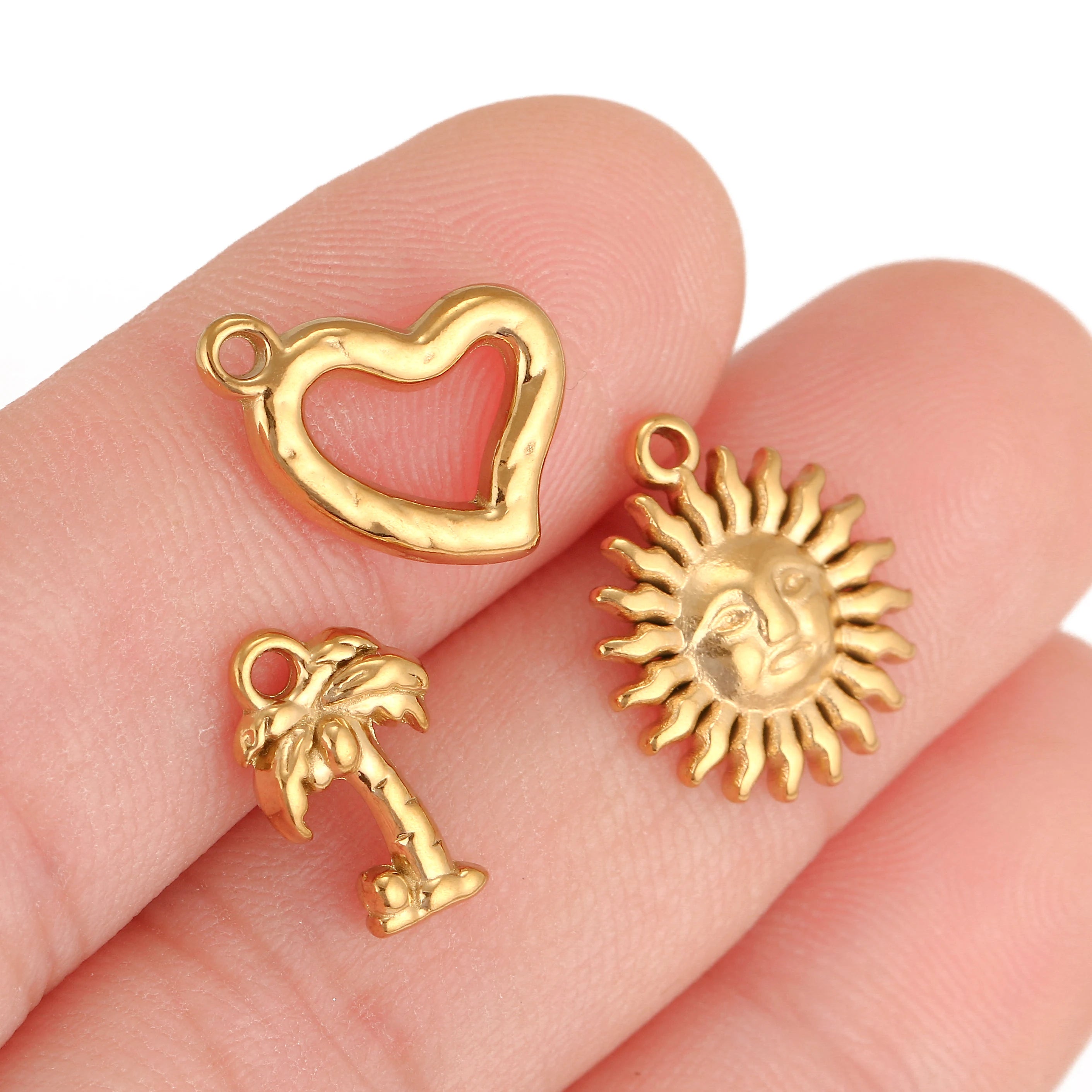 Gold-toned stainless steel heart, sun, and palm tree charms for DIY pet jewelry, necklaces, and bracelet making.
