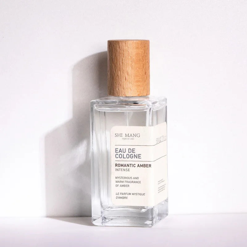 Shi Mang Romantic Amber 50ml EDP: Women’s woody amber fragrance in a luxury rectangular bottle with wood-grain cap.