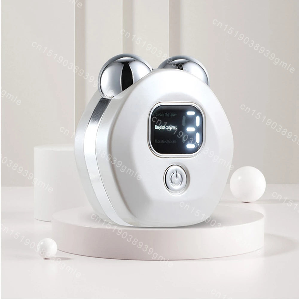 White round facial massager with two silver rollers, a digital display screen, and a power button on a platform.