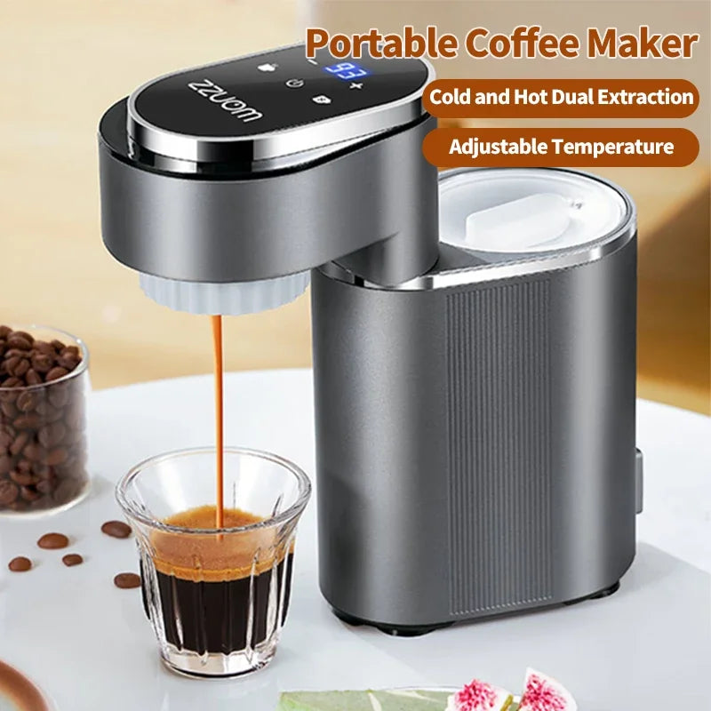 Gray ZZUOM portable coffee maker with digital temperature display, pouring espresso into a small glass cup.