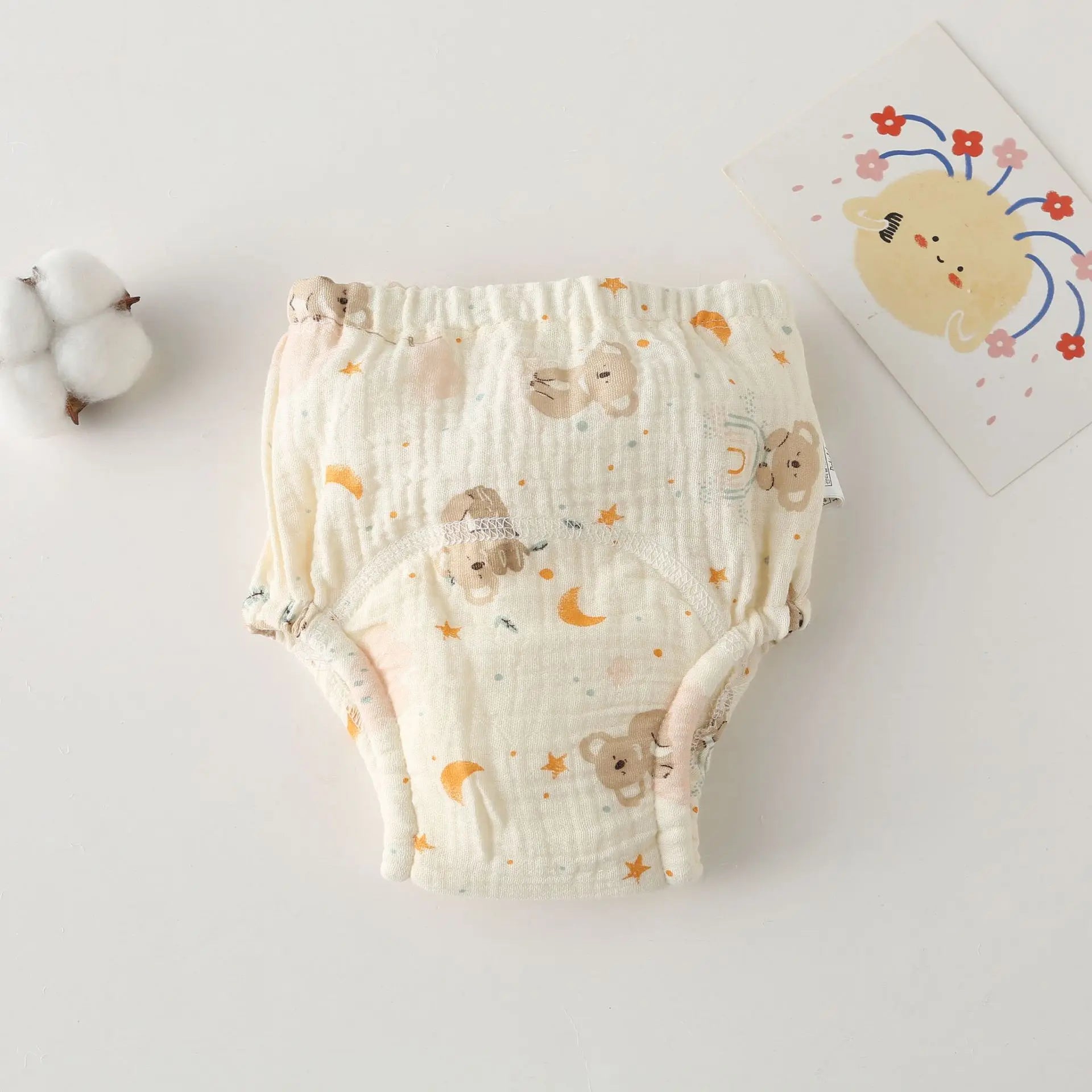 Cotton baby diaper with bear and moon print, soft muslin training pants for infants, baby care essentials.