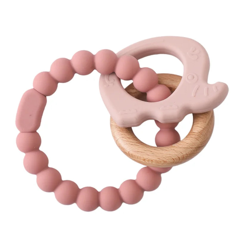 Pink silicone and natural wood elephant baby teething ring toy for infant teething relief.