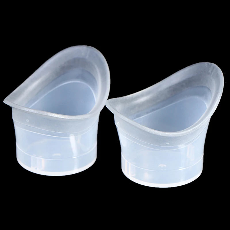 Pair of reusable soft silicone eye wash cups for gentle eye flushing and cleaning on black background.