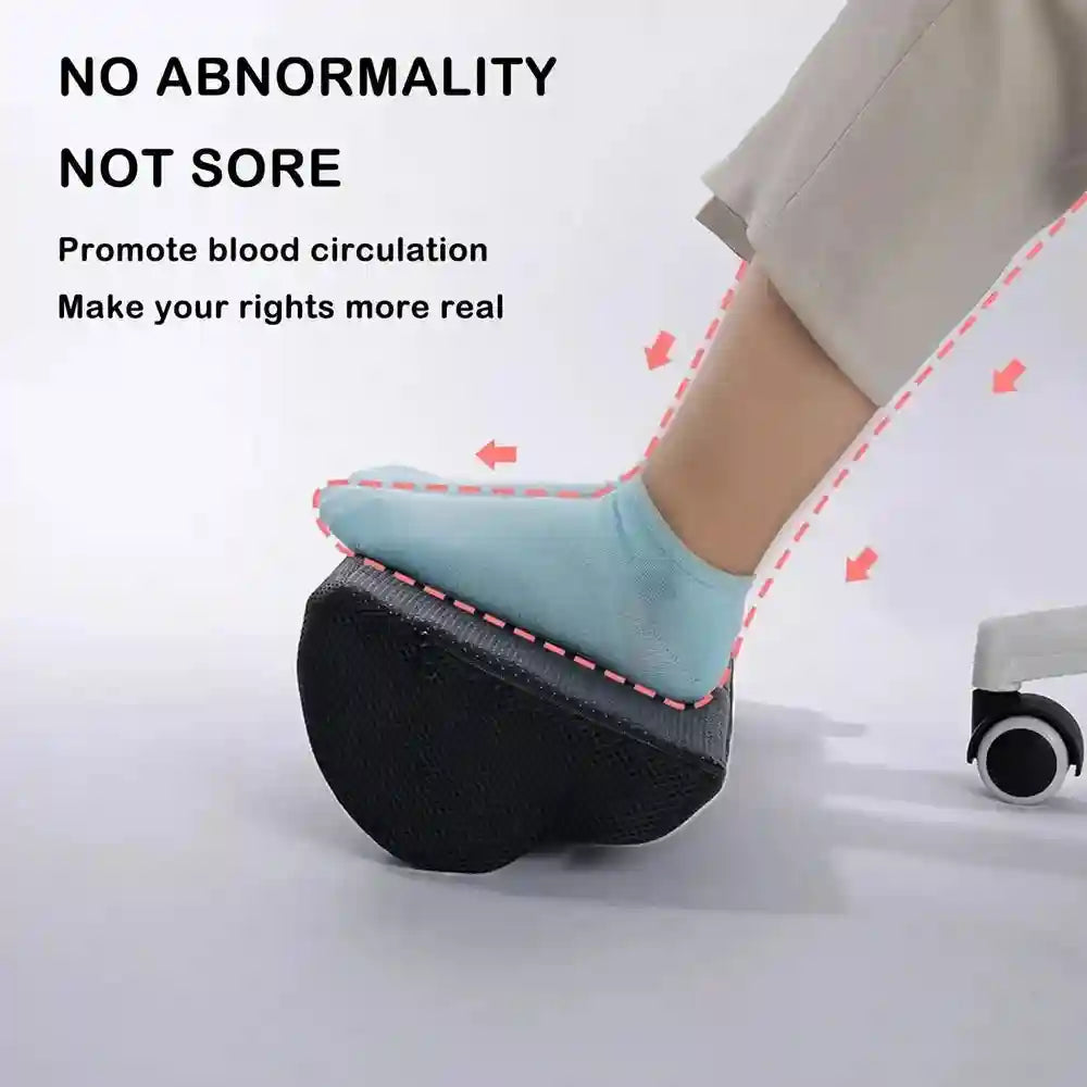 Black memory foam under-desk foot rest for ergonomic office support and improved leg circulation.