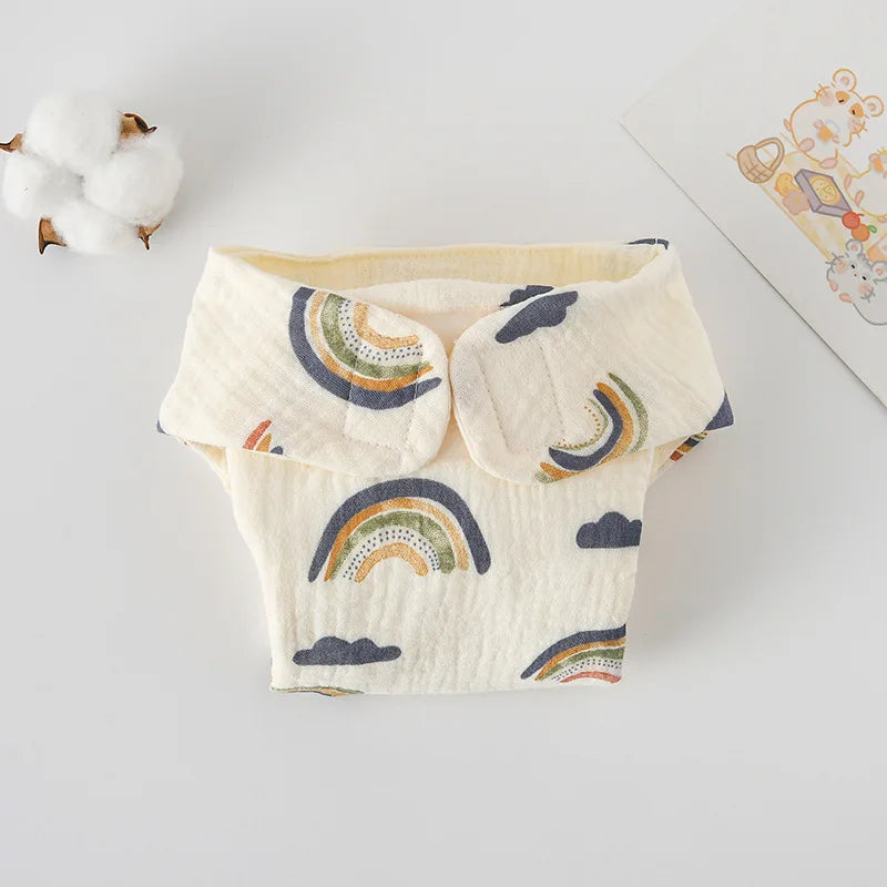 Reusable cloth baby diaper with cream base and rainbow and cloud print.