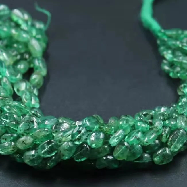 Smooth green oval beads strand with glossy highlights, for jewelry making