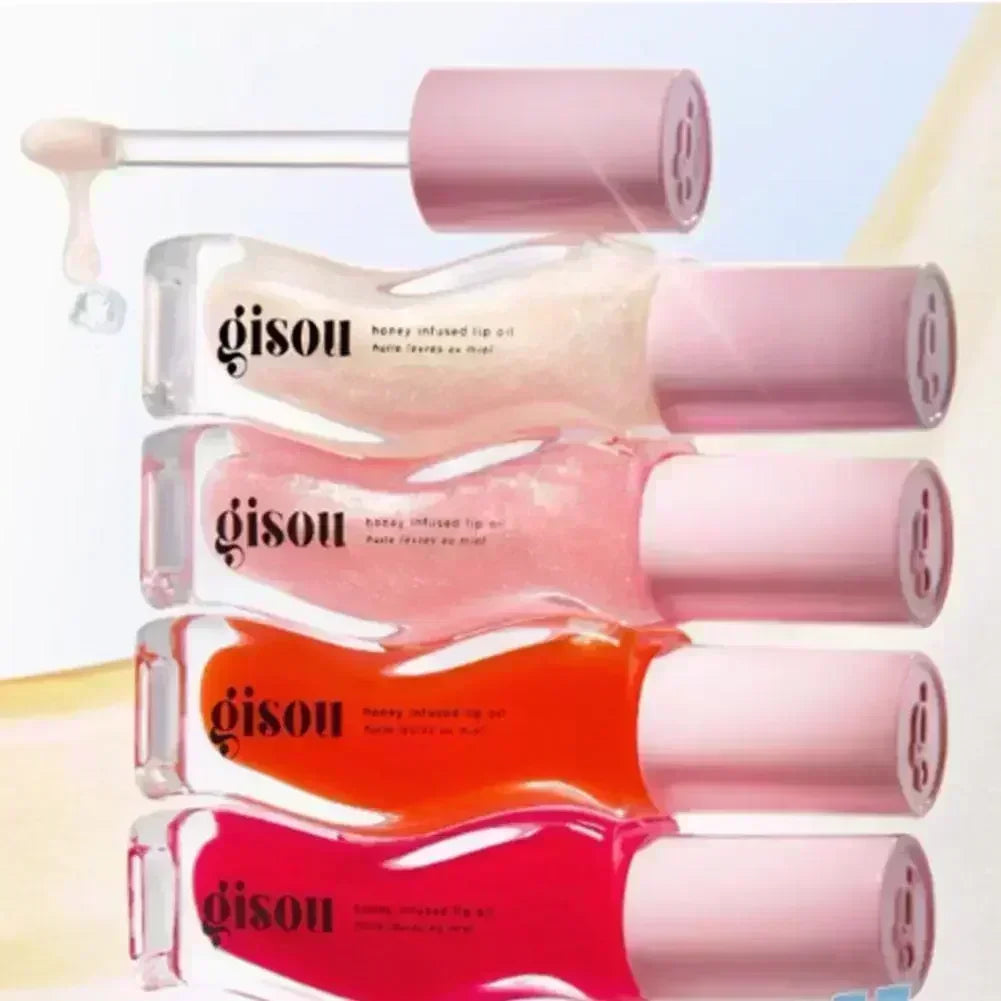 Gisou moisturizing honey-infused lip oils in clear, pink, orange, and red shades with glossy, hydrating liquid texture.