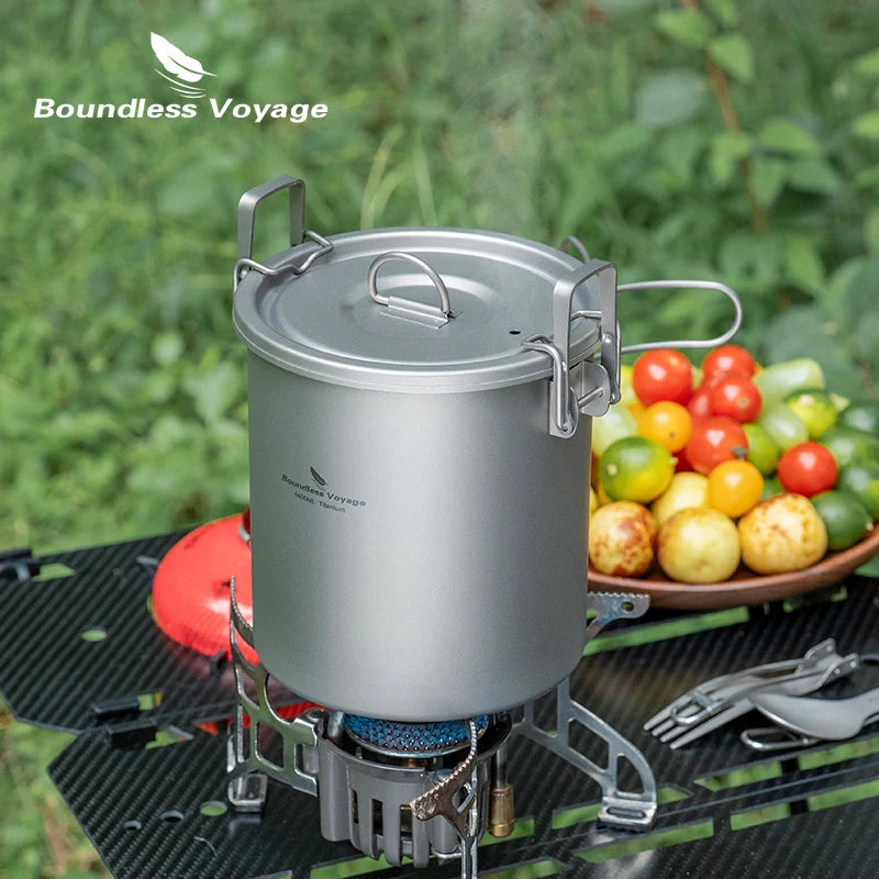 Titanium cooking pot with lid on a foldable camping stove, silver
