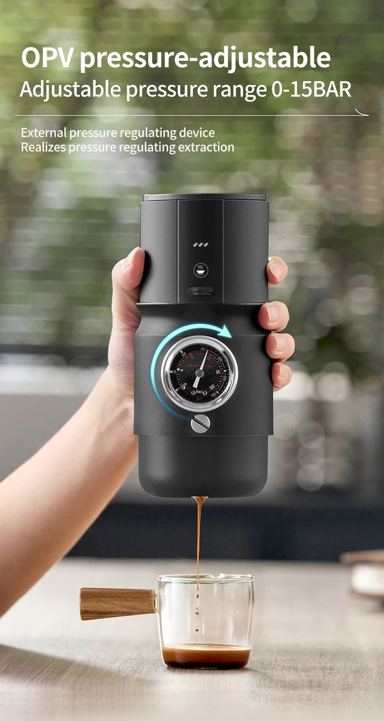 Handheld black portable espresso maker with manual 0-15 bar pressure gauge brewing into a glass cup.