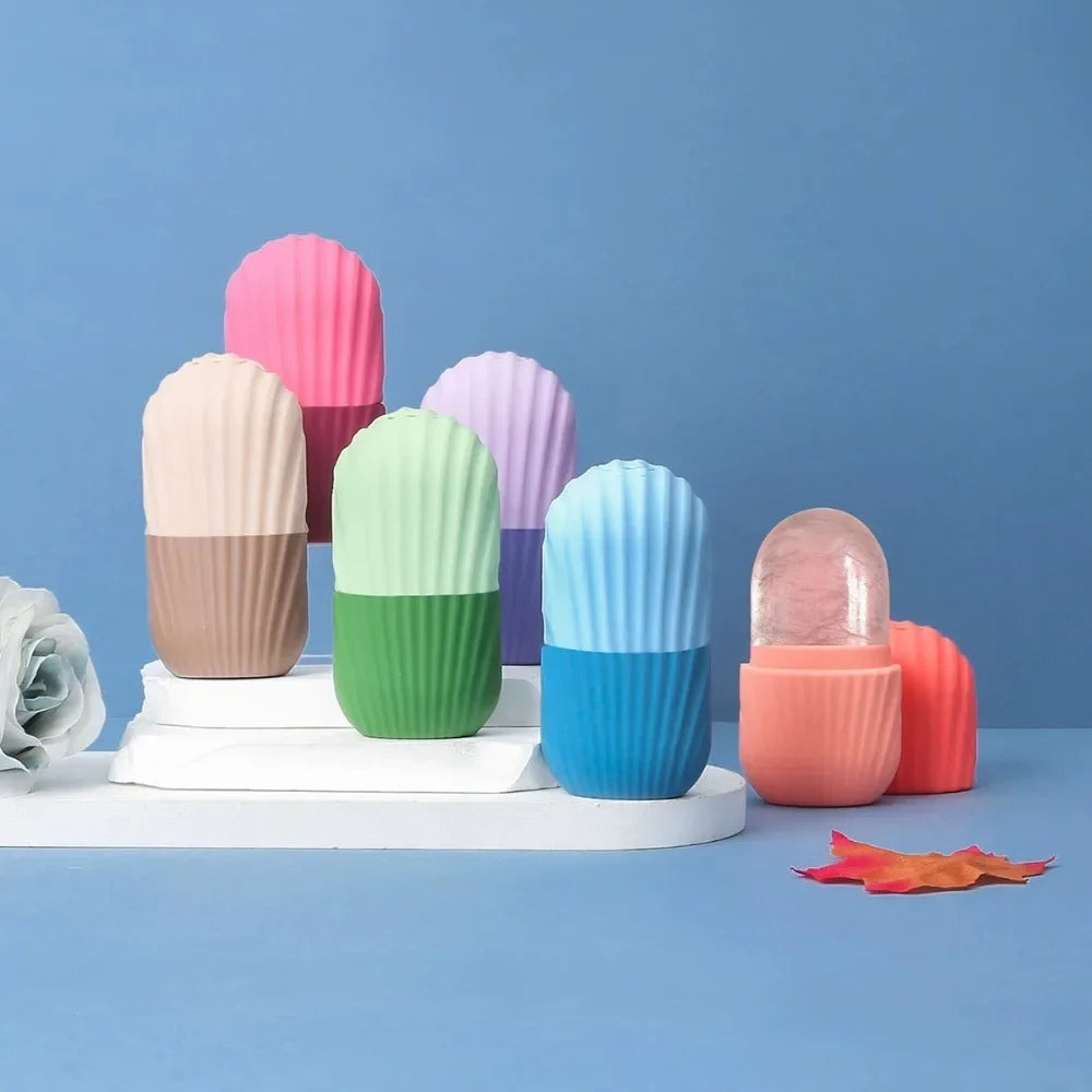 Group of colorful, ribbed silicone ice face rollers standing on a white display against a blue background.