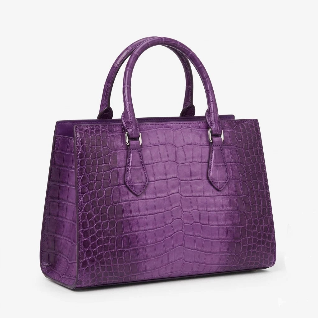 Purple genuine leather handbag with luxury alligator-embossed texture, dual handles, and structured designer style.