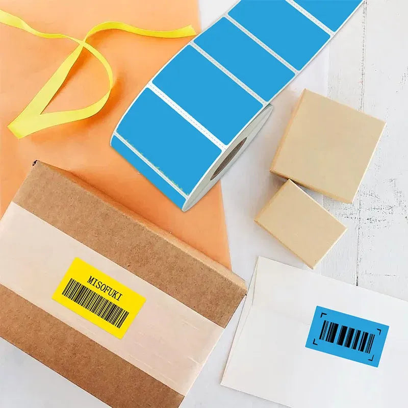 Blue thermal label sticker roll and barcode labels on shipping boxes
