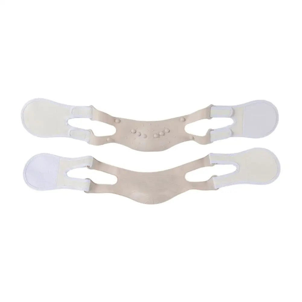 Two beige, reusable facial slimming chin straps with adjustable side tabs and massage nodules.