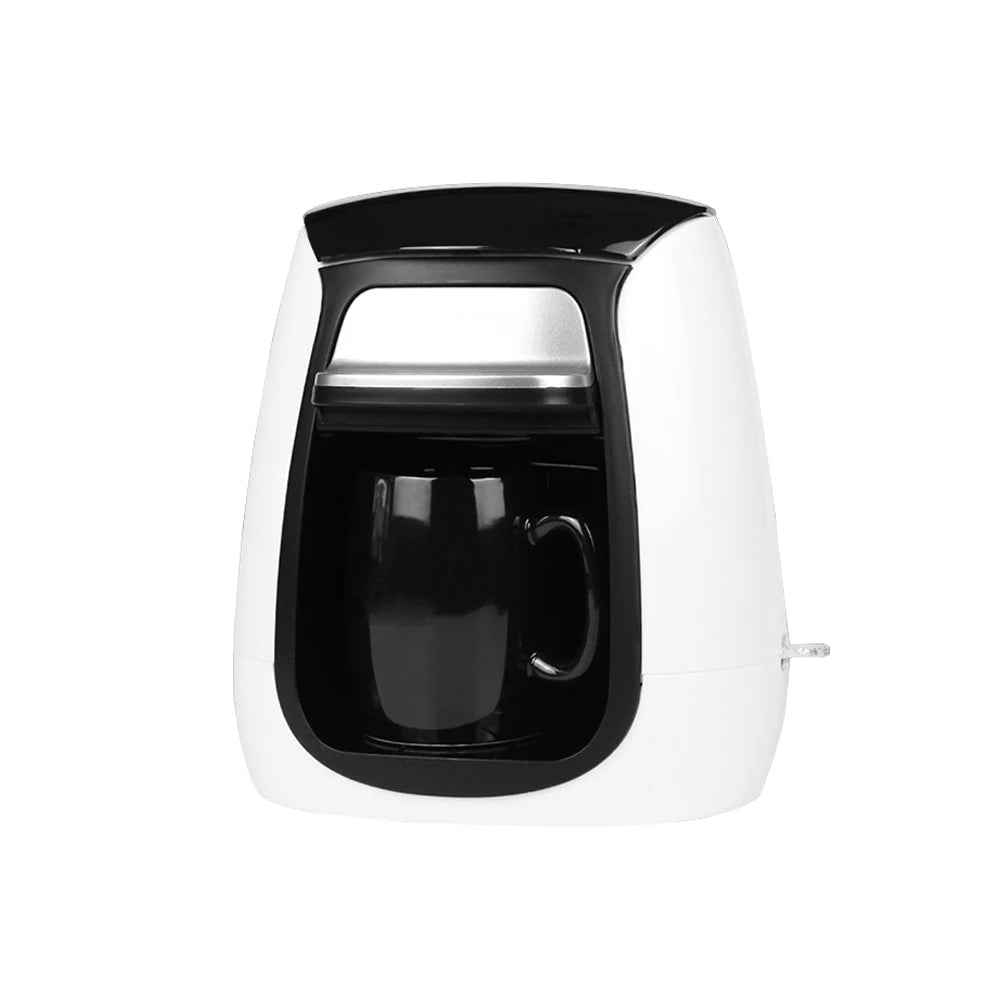 Compact white and black single-serve coffee maker with a matching black mug, modern kitchen appliance design.