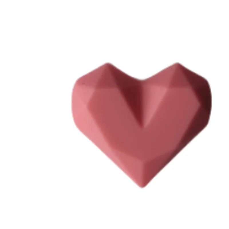 Pink heart silicone dust plug for Tamagotchi Uni electronic pet; protects charging port from dirt and debris.