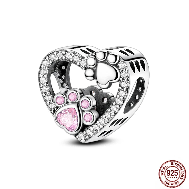 Heart-shaped 925 sterling silver dog paw charm with pink cz crystal for charm bracelets and DIY pet jewelry.