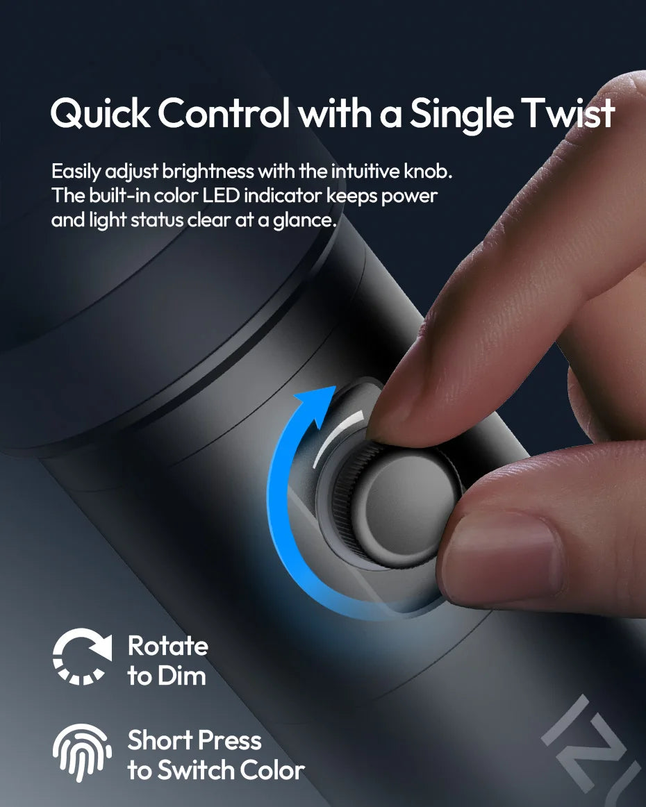 A finger rotates a small, matte black cylindrical control knob on a light device to adjust brightness settings.