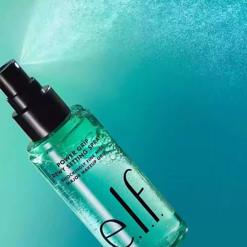 e.l.f. Power Grip Dewy Setting Spray in a green bottle with fine mist nozzle for long-lasting, hydrated makeup finish.