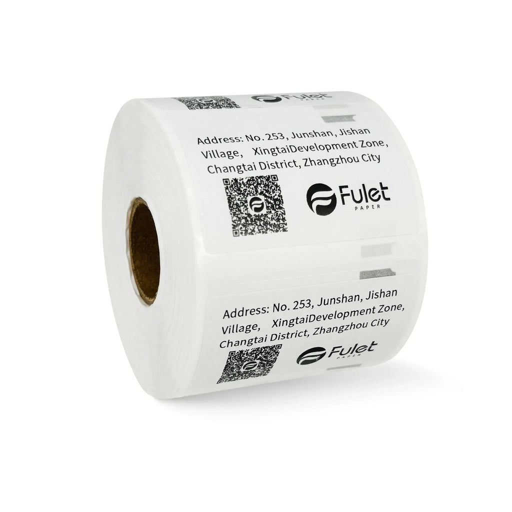 White barcode label roll with printed address labels and QR codes, side view.
