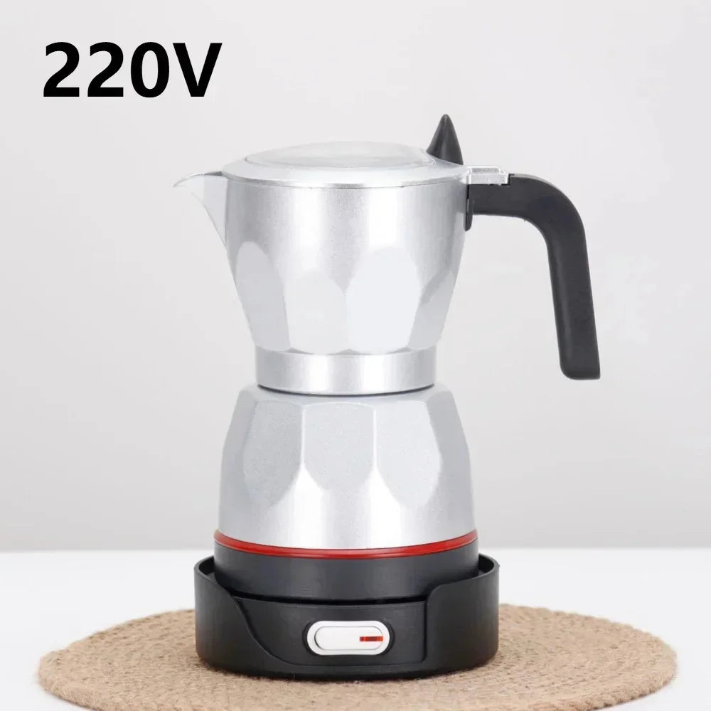 Silver aluminum electric moka pot coffee maker, 220V, with black handle and base, on a circular woven mat.