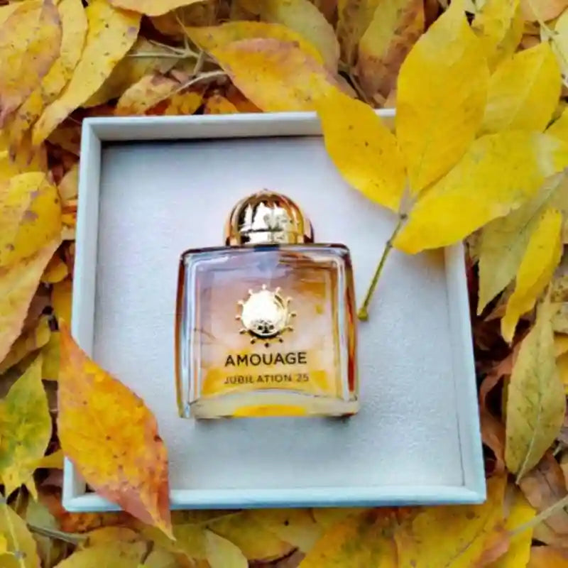 Amouage Jubilation 25 Women's EDP: 100ml floral oriental chypre perfume in a gold-capped square bottle on autumn leaves.
