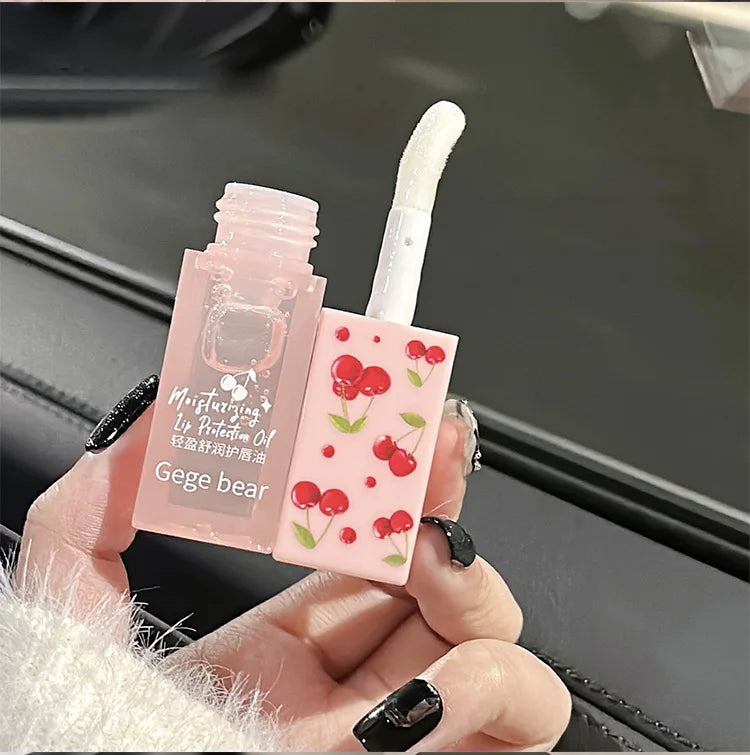 Gege Bear cherry lip oil with clear moisturizing texture and cute pink cherry-print applicator cap.