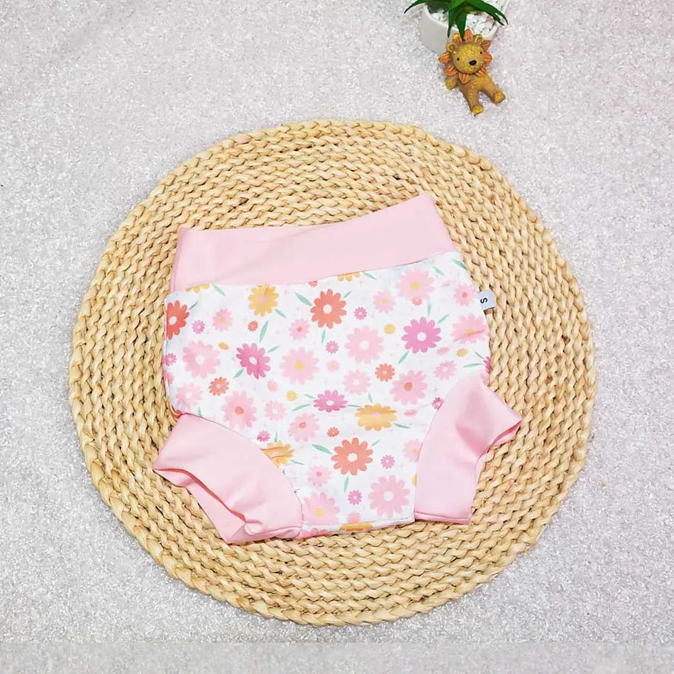 Size S baby swim diaper with pink floral print and solid pink trim for infant care.
