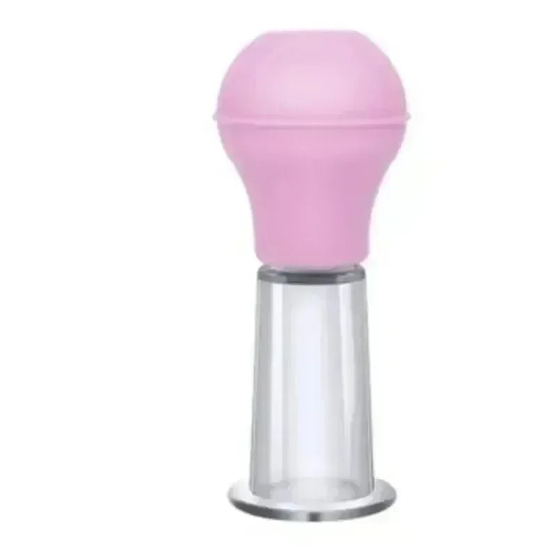 A pink rubber suction bulb attached to a clear, bell-shaped vacuum cupping jar for facial massage.