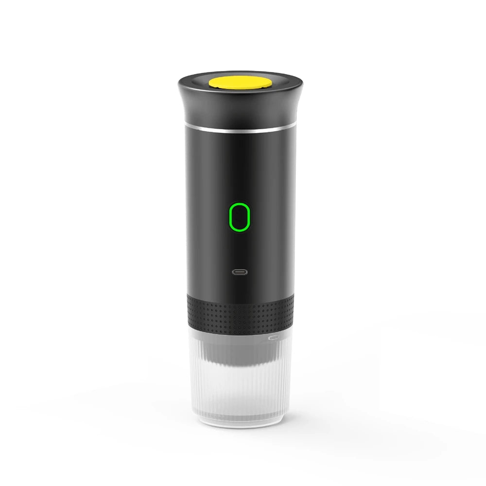 Portable black electric espresso maker with yellow top button, green LED power light, and clear bottom cup.