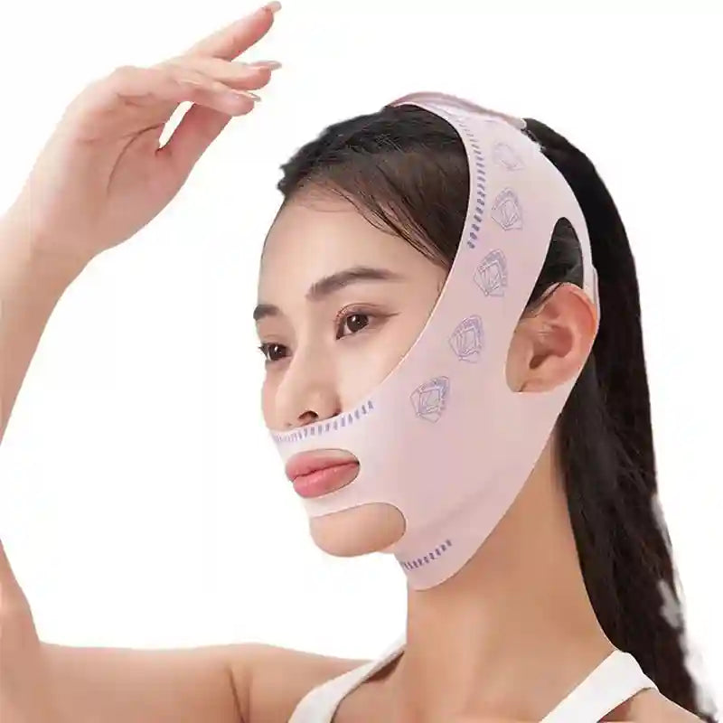A person wearing a light pink, fabric face-slimming bandage with purple fan-shaped patterns on the sides.