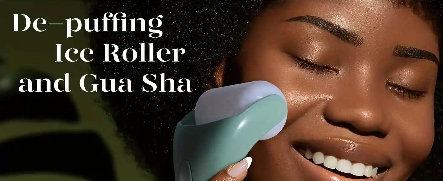 A person uses a handheld light green ice roller with a white cylindrical head on their cheek for facial massage.