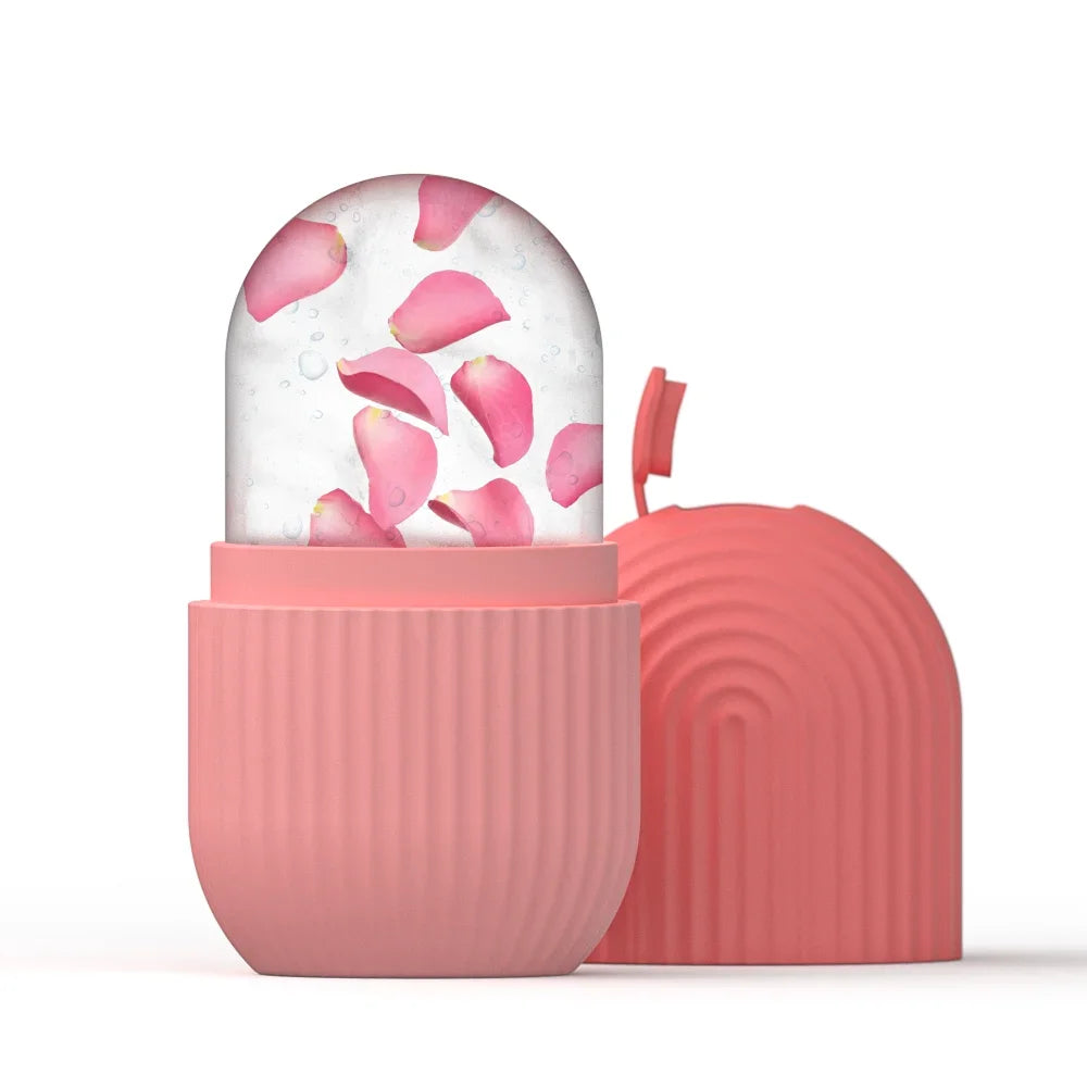Pink silicone ice roller mold with a frozen ice cylinder containing rose petals, and a matching ribbed cap nearby.