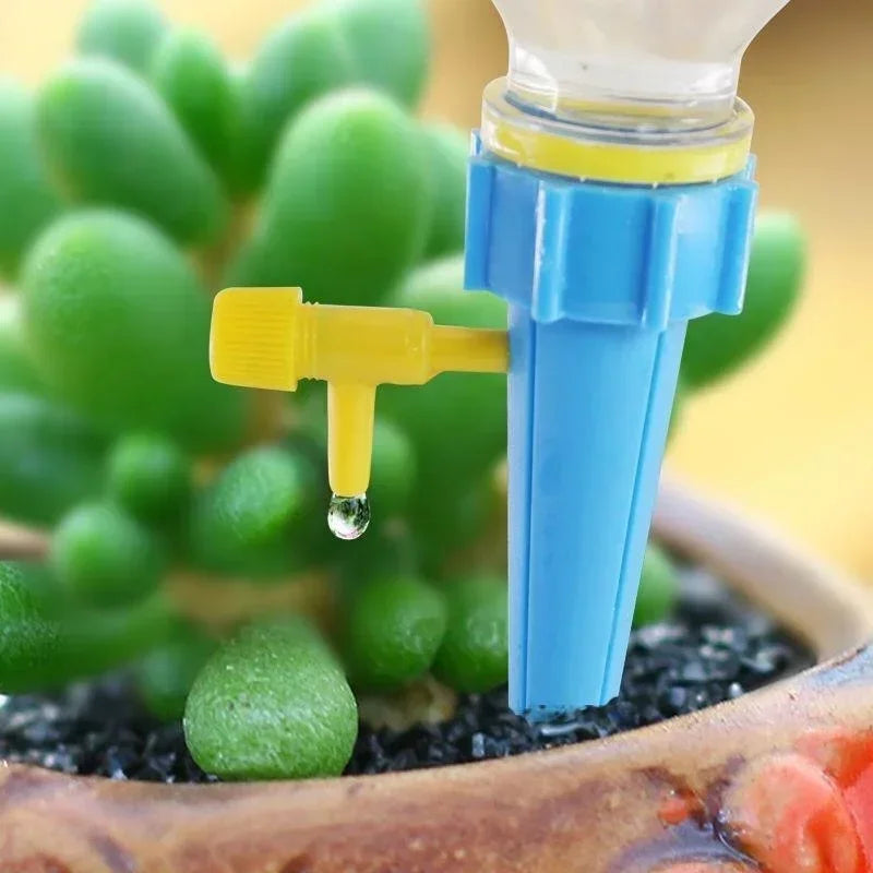 Blue adjustable drip irrigation spike with yellow emitter releasing a water droplet.