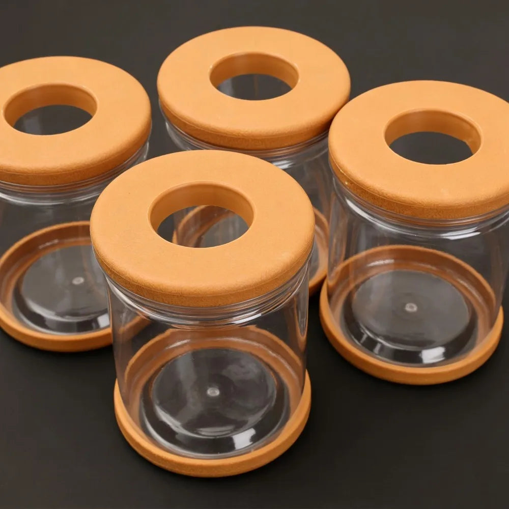 Set of clear hydroponic glass pots with orange round lids and circular top openings