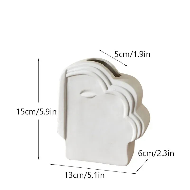 White ceramic face vase with rounded top spout and side cutout, 15cm height