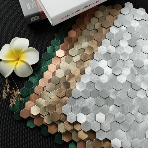 Mixed metallic hexagon peel-and-stick backsplash tile sheet in green, bronze, and silver tones