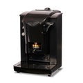 Faber black pod espresso machine with brass brewing group and manual lever, compact countertop design.