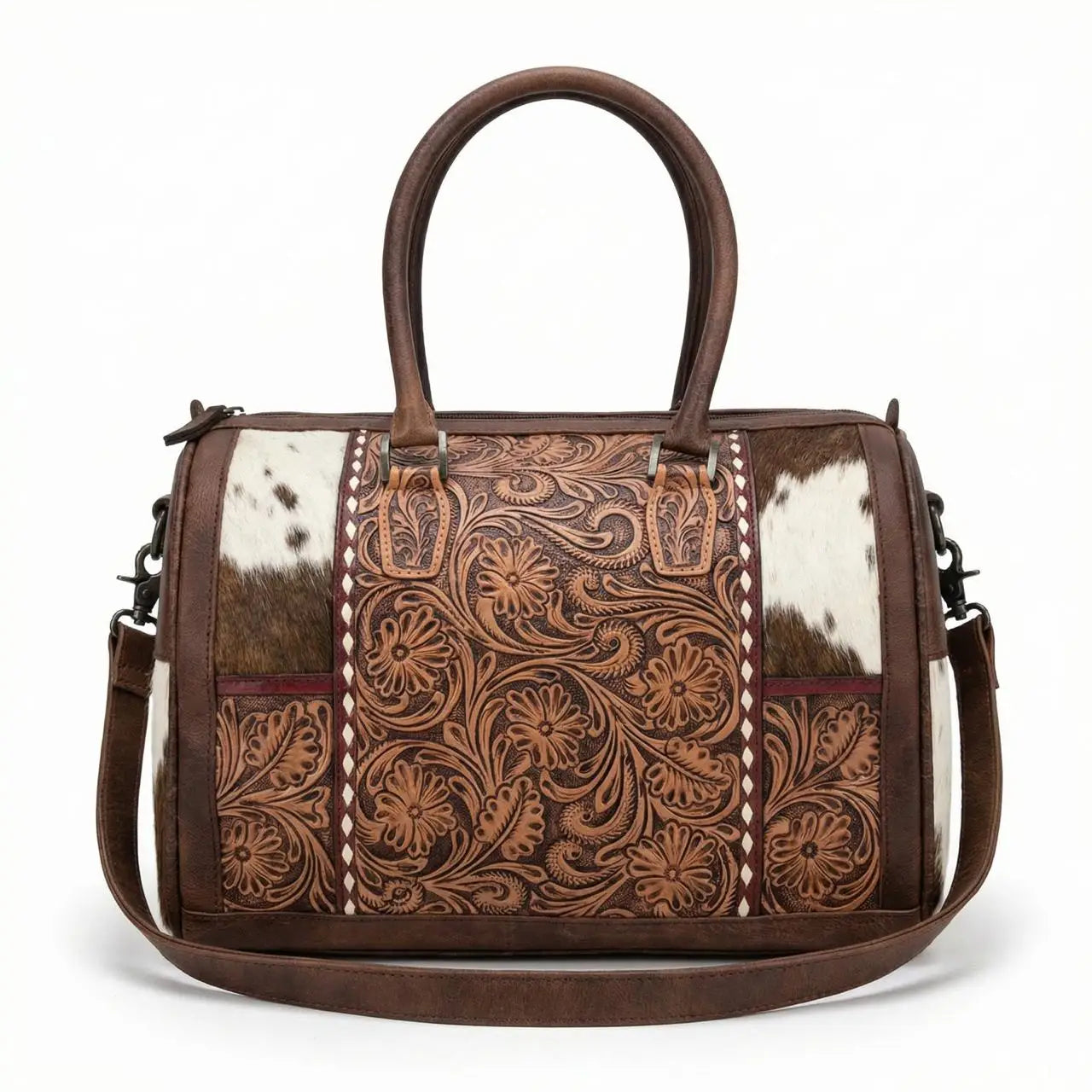 Mini brown leather duffel bag with floral tooling, cowhide panels, top handles, and a detachable shoulder strap.