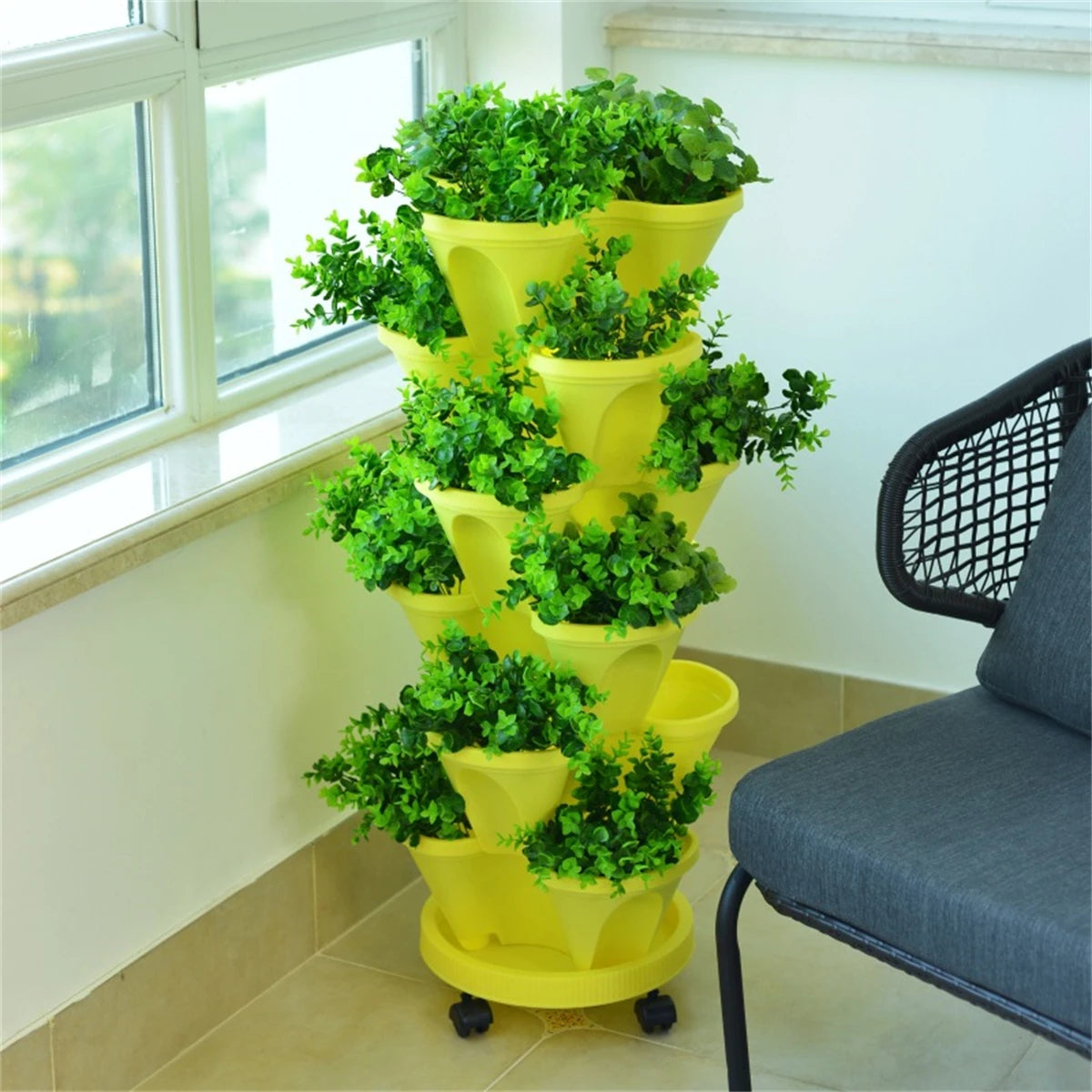 Yellow stackable vertical herb planter with four-tier pots and small caster wheels