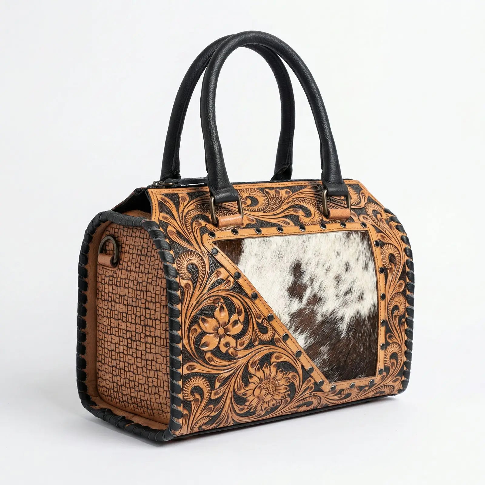 Handmade luxury weekender bag in tan genuine leather with floral tooling, black trim, and a cowhide hair-on-hide panel.