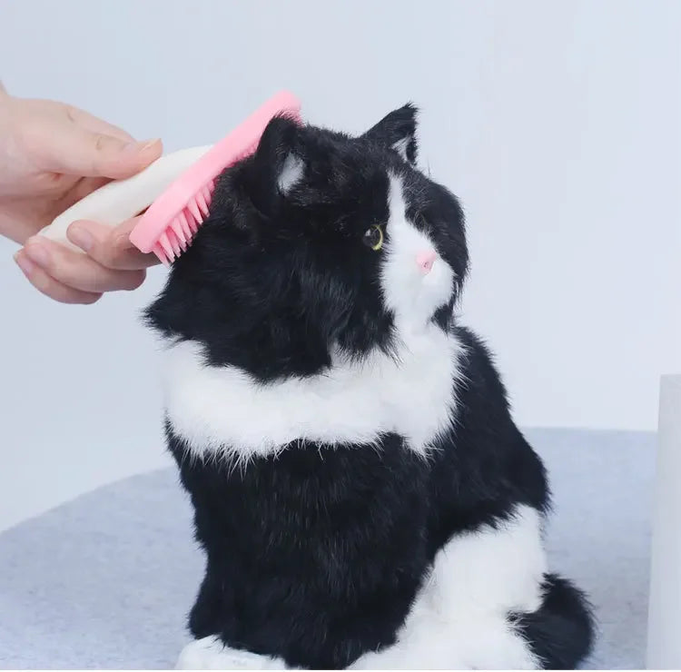 Pink silicone small pet comb grooming a cat's fur. Gentle brush for rabbit, guinea pig, and cat hair care.