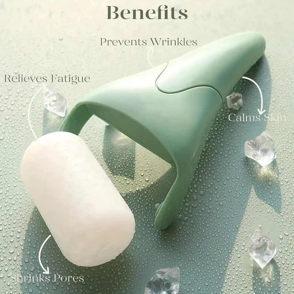 A sage green handheld facial ice roller with a white cylindrical roller head resting on a wet, water-dropped surface.