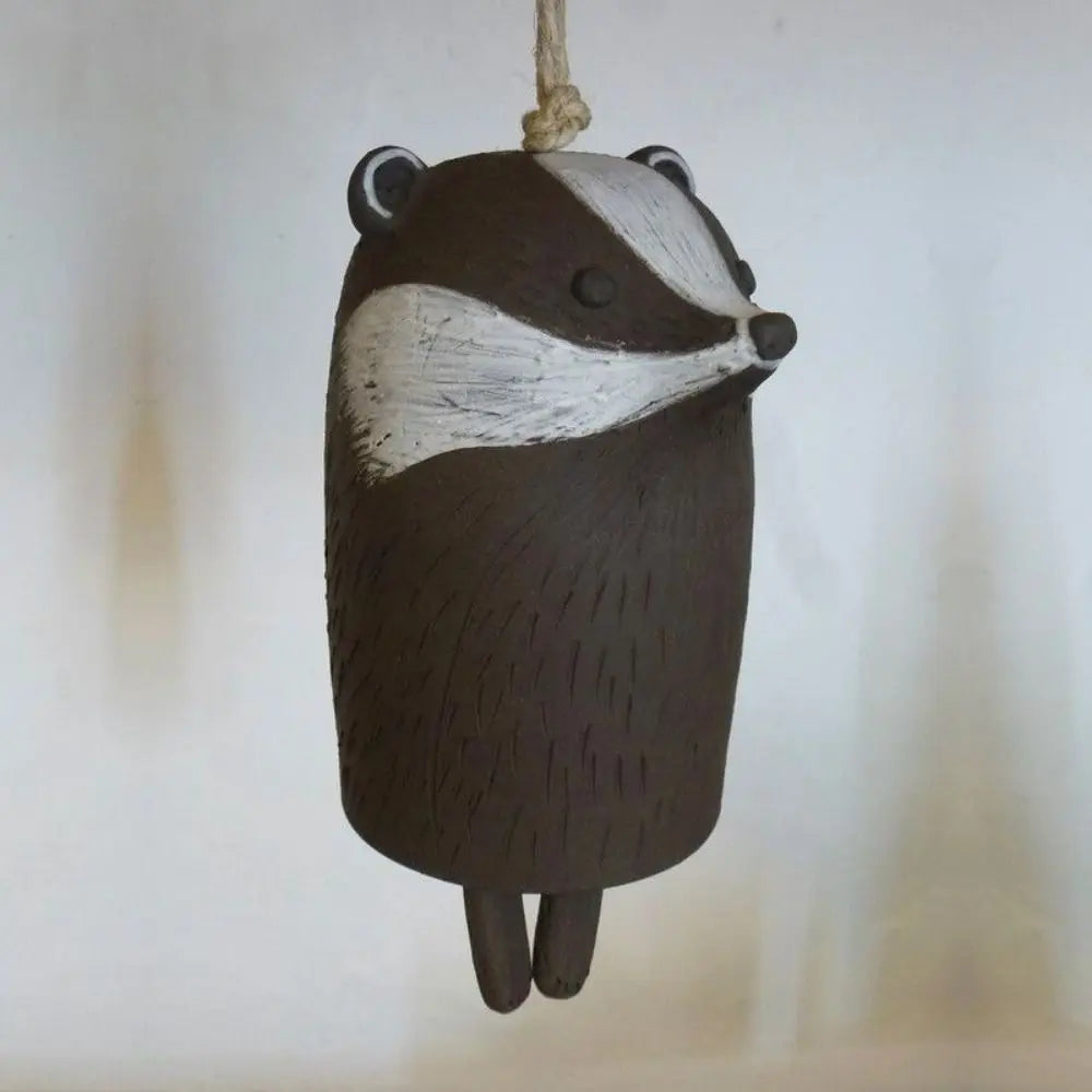Cute brown and white badger resin wind chime for rustic garden decor or a unique outdoor gift.